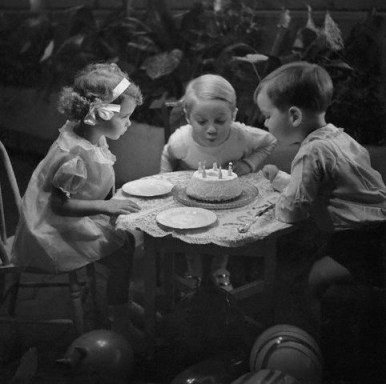 little kids blowing out birthday cake by Foxtongue at flickr